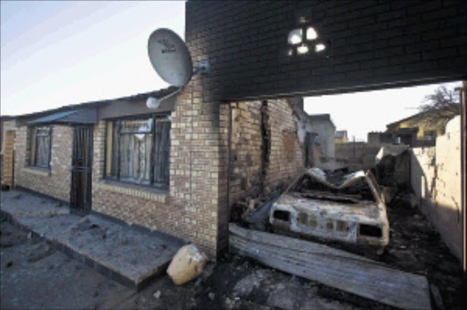 The home and car of former city councillor Mirriam Ramafola in Tshiawelo, Soweto. A group attacked the house while Ramafola and her children were inside on Tuesday Picture: HALDEN KROG