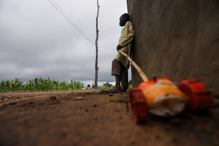 A boy leans against a wall with a toy car near the place where several Islamic students were kidnapped by bandits in Tegina, Niger State, Nigeria, August 11 2021. Picture: REUTERS/AFOLABI SOTUNDE