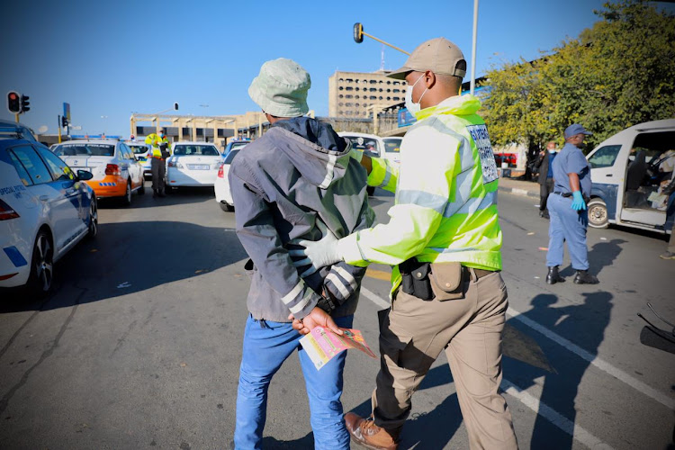 A man was arrested, after he was found with non-essential goods for sale without a permit at Bara taxi rank in Soweto, south of Johannesburg on April 23 2020.