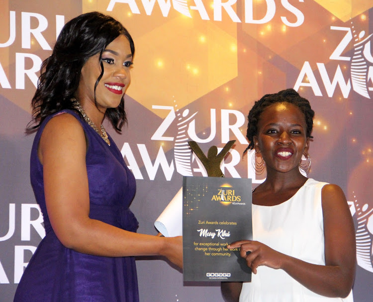 Renewable energy category winner Mary Kibui receives her award from Victoria Rubadiri