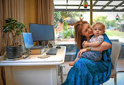 Lauren Campbell with her 15-month-old son, Daniel. She says she is looking forward to going back to her office  because productivity is a challenge  with a toddler to look after while she is trying to work.