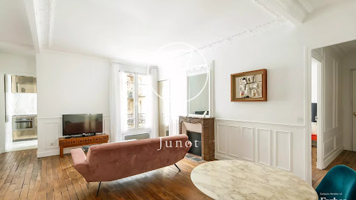Luxury apartment / penthouse for sale in Paris 18ème (75018) - living room with fireplace and pink sofa