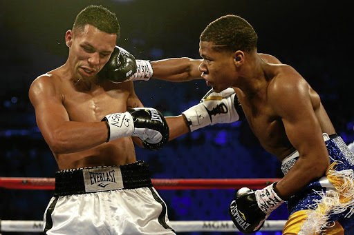 Devin Haney, right, lands a right punch onto Rafael Vazquez's head.