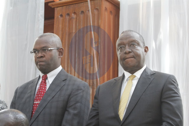 Treasury PS Kamau Thugge and CS Henry Rotich at a Milimani law court on Tuesday, July 23, 2019.