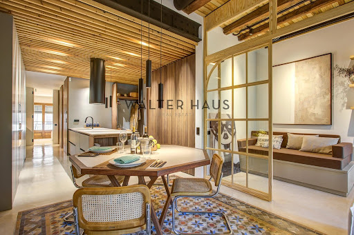 Buy this luxury apartment / penthouse in Barcelona (Spain) - Modern kitchen island and wood paneling
