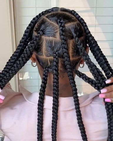 Back view of  a lady rocking her large knotless braids