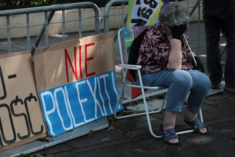 A woman sits in front of the Constitutional Tribunal during a hearing in Warsaw, Poland, July 13 2021. Picture: SLAWOMIR KAMINSKI/REUTERS