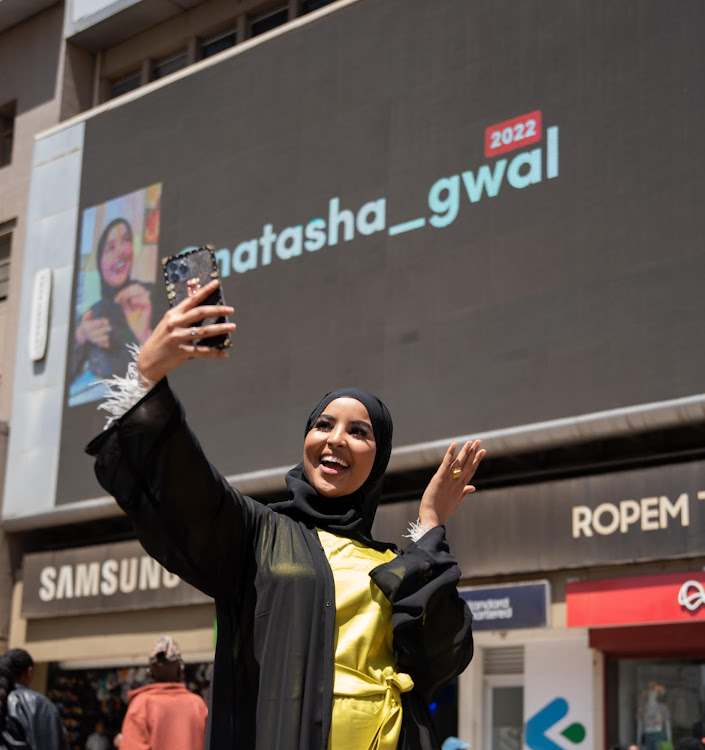 A billboards with #TopCreator2022 finalists, Natasha Gwal, popularly known as @natasha_gwal