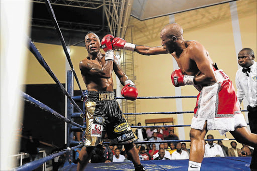 VETERAN FURY: Simpiwe ‘V12’ Vetyeka stopped Thompson Mokwana in the eighth round with a barrage of punches during their lightweight bout at the Orient Theatre in East London on Friday evening Picture: MARK ANDREWS