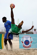 Moeva Chakira of Comoros strike an overhead kick while Yahaya Said Tumbo of Tanzania tries to make a stop during COSAFA Beach Soccer Tournament in Durban. 
 Image: SANDILE NDLOVU