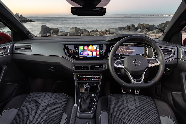 The modern cabin features a digital instrument panel and a soft-touch dashboard.