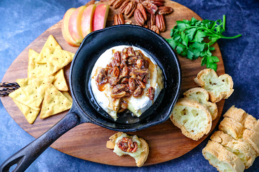 Candied Nuts and Brie Dip with apples, bread, and crackers.