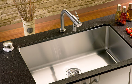 chrome kitchen sink on black worktop