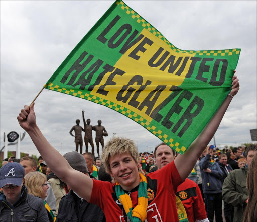 Supporters protest against Manchester United's US owner Malcolm Glazer before the English Premier League football match between Manchester United and Stoke City at Old Trafford in Manchester, north-west England. File photo