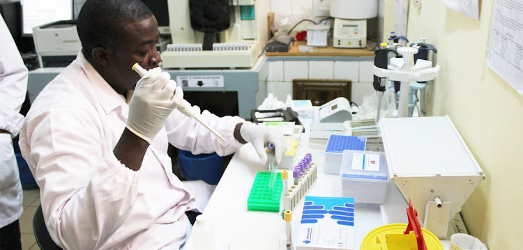 A researcher stores vials of the R21 malaria vaccine.