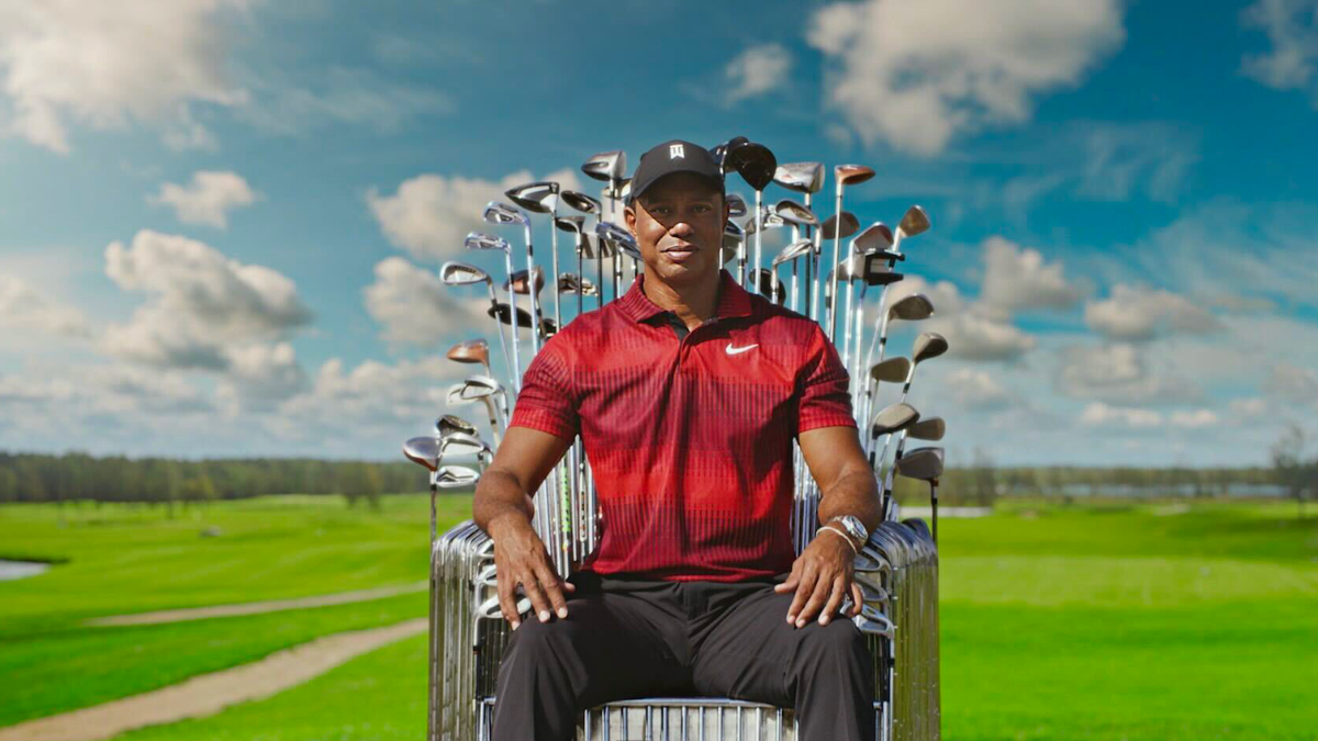 tiger woods sitting in throne of golf clubs