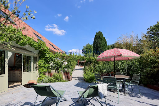 Paved terrace with garden furniture in this luxury longere for sale in Doudeauville ($894,596 - 360 m²)
