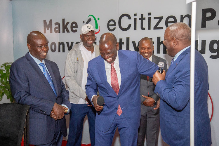 President William Ruto breaks into laughter during launch of 5,000 digitised government services at KICC on June 30, 2023.