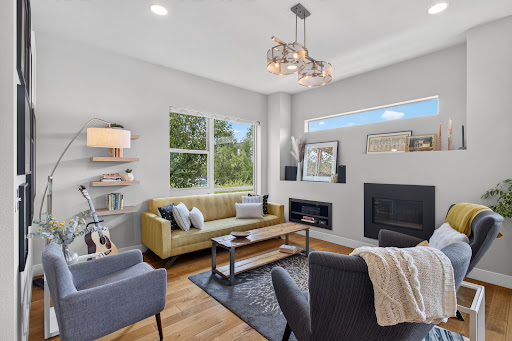 Modern living room with yellow sofa and fireplace - Buy this luxury property in Denver, 4 bedrooms