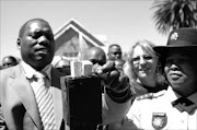 LEADING LIGHT: Premier Zweli Mkhize lights a candle of hope in Estcourt yesterday. Pic. SIYABONGA MOSUNKUTU. 25/11/2009. © Sowetan.