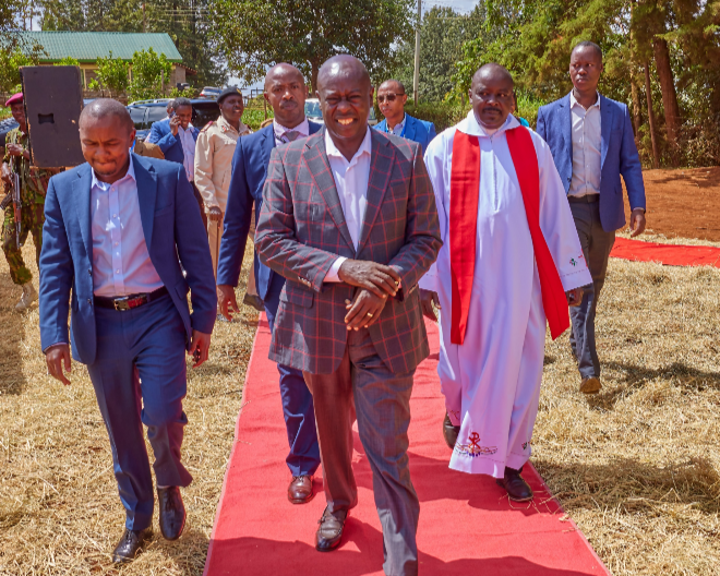 Deputy President Rigathi Gachagua with Kigumo MP Joseph Kinyoro at Muthithi Catholic church in Murang'a.