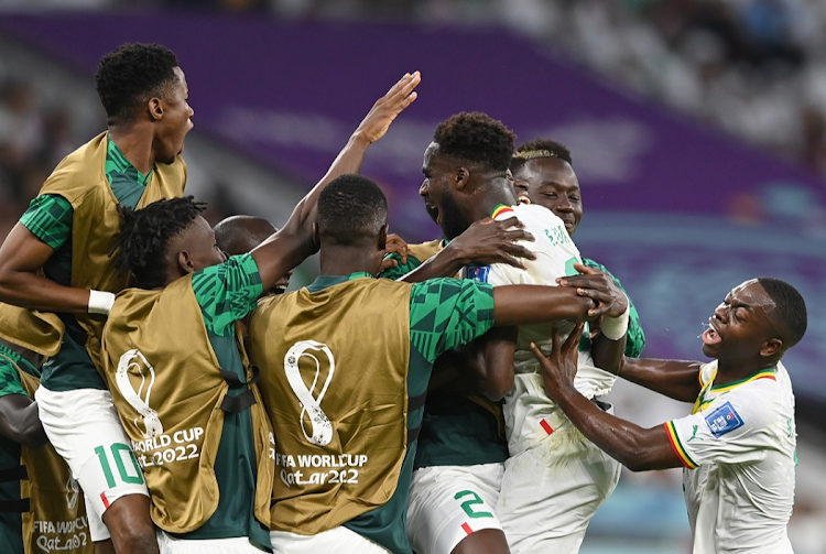 Boulaye Dia of Senegal (centre) celebrates after scoring their first goal in the World Cup Group A match against Qatar and Senegal at Al Thumama Stadium in Doha, Qatar on November 25, 2022.