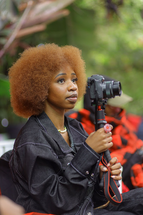 Kenyan content creator Temina Kavelwa follows proceedings during the Google Africa Celebrates Alte event in Nairobi