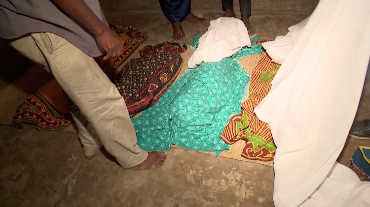 Bodies covered with clothes lie on the ground following a ferry accident in Nampula Province, Mozambique, in this screen shot from a video, April 8 2024. Picture: TELEVISION OF MOZAMBIQUE/REUTERS