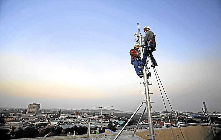 Technicians install a cellphone tower in East London. File photo.