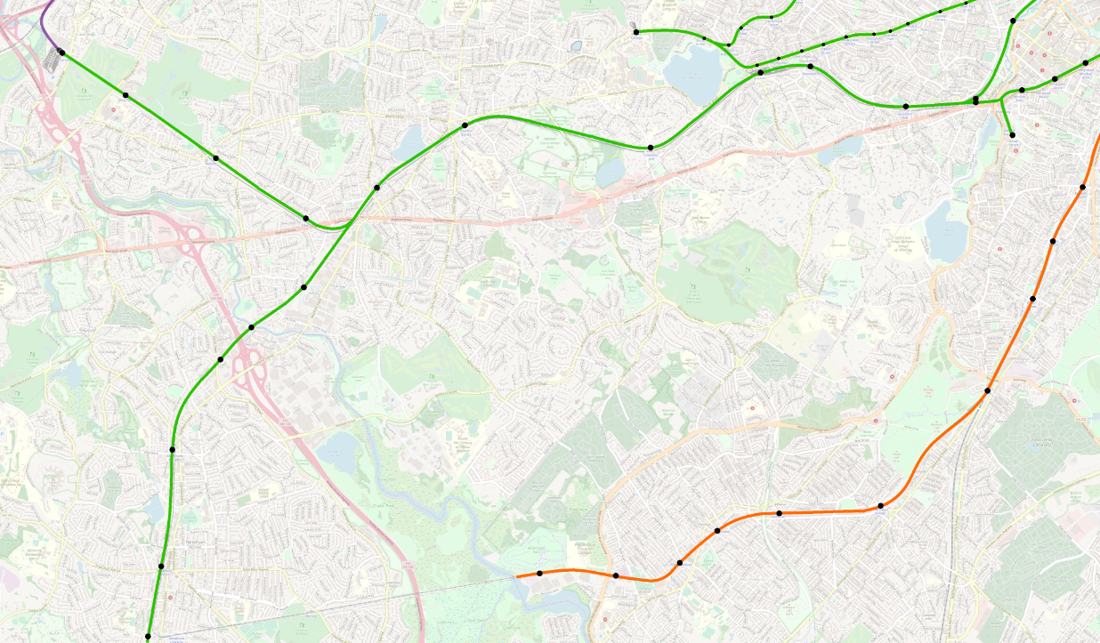 A map of the current MBTA rapid transit system, focused on Newton, Brookline, Needham, Jamaica Plain, Roslindale, and West Roxbury. The Orange Line has been extended along the Needham Line ROW to a station just past the VFW Parkway at Millennium Park, with intermediate stops at Roslindale Village, Bellevue, Highland, West Roxbury, and VFW Parkway. A new branch of the Green Line has been added, branching west of Newton Highlands, heading southwest to Newton Upper Falls, New England Business Center, Gould Street, Needham Heights, Needham Center, and Needham Junction. Additional extensions visible include a D-E connector between Brookline Village and Riverway, and Indigo Line service to Riverside via Auburndale