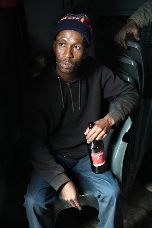 Sipho Nkosi having his beer in a tavern in Orlando , Soweto.