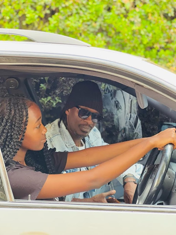 Nameless teaching his first born daughter Tumiso how to drive