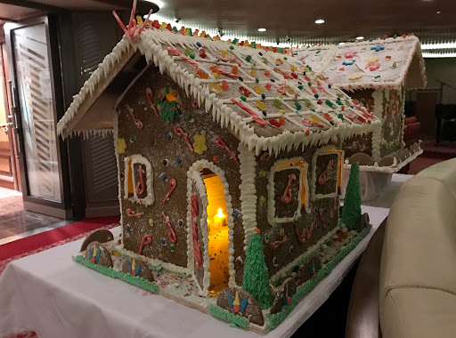 A gingerbread house lit up in the Panorama Lounge on Silver Spirit during the holidays. 