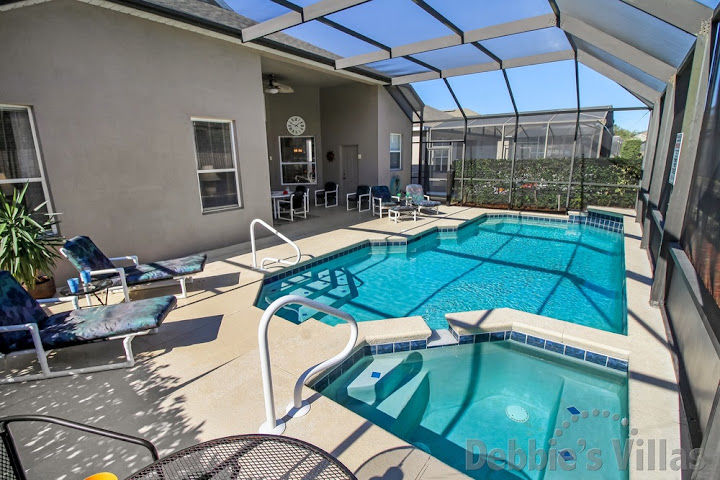 Handrails and steps to assist entry into the pool and spa at this Windsor Palms villa