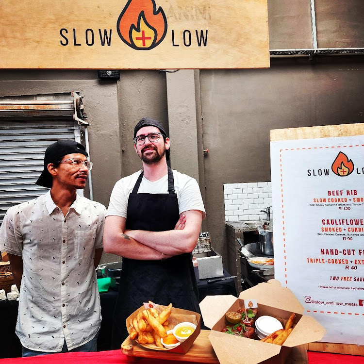 Business partners Lester Adams and Connor Wolstencroft, who have the Slow + Low food stall at the Neighbourgoods weekend market at Cape Town's Old Biscuit Mill, have taken a hit as their growing business has been knocked again as travel bans have emptied the city of tourists.