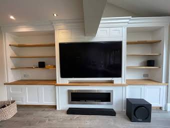 Media wall with solid oak bracketless shelves. album cover