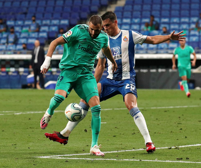 Real Madrid's Karim Benzema in action with Espanyol's Bernardo Espinosa