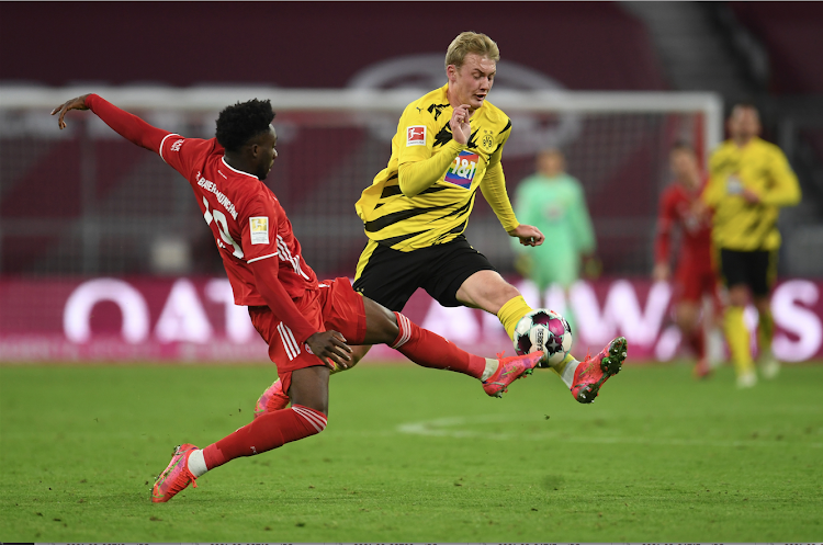 Bayern Munich's Alphonso Davies in action with Borussia Dortmund's Julian Brandt