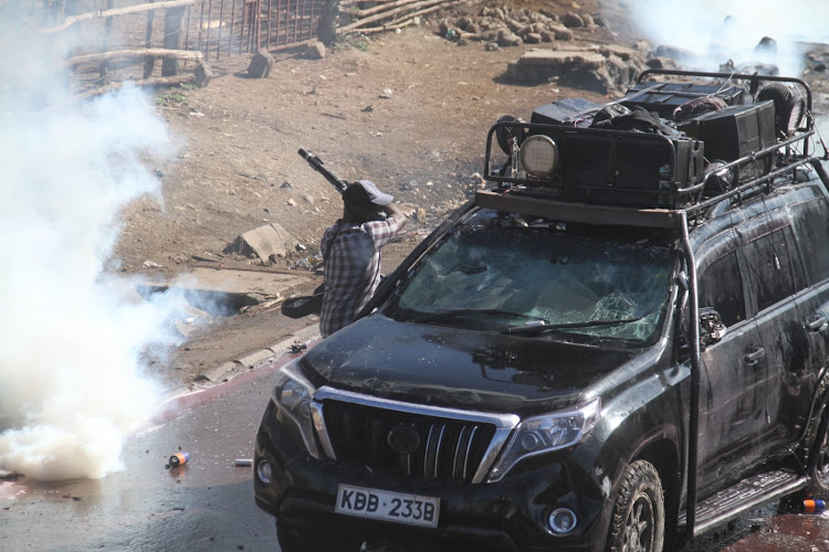 A plainclothes police officer is captured on tape hitting a press vehicle during Thursday's mass action in Embakasi South, Nairobi, March 30, 2023.