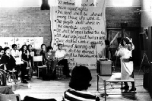 PEOPLE'S WISHES: Delegates discuss the clauses of the Freedom Charter in Kliptown in 1955. Pic. Unknown