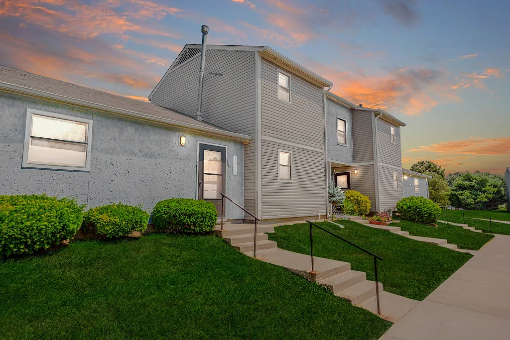 Overbrook Hills apartment building with light exterior at dusk