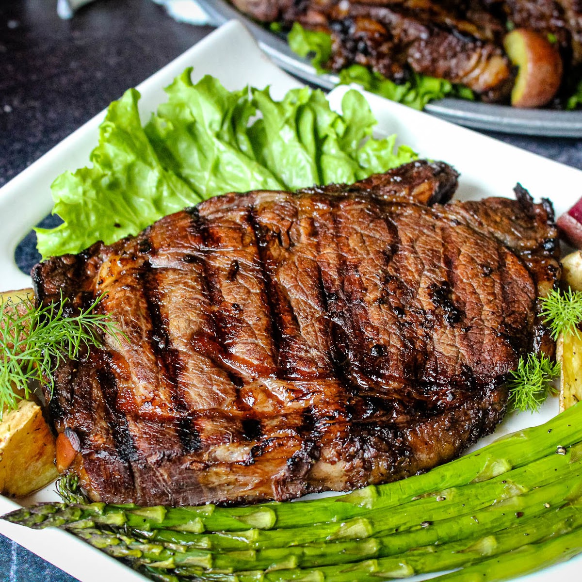 How to Cook Ribeye Steak on the Grill - Garnished Plate