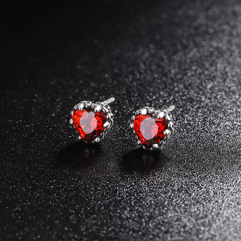 Pendientes S925 Keke Iris de plata esterlina, circonitas rojas de Año Nuevo. Elegancia y brillo festivo, perfectos para celebrar con estilo.
