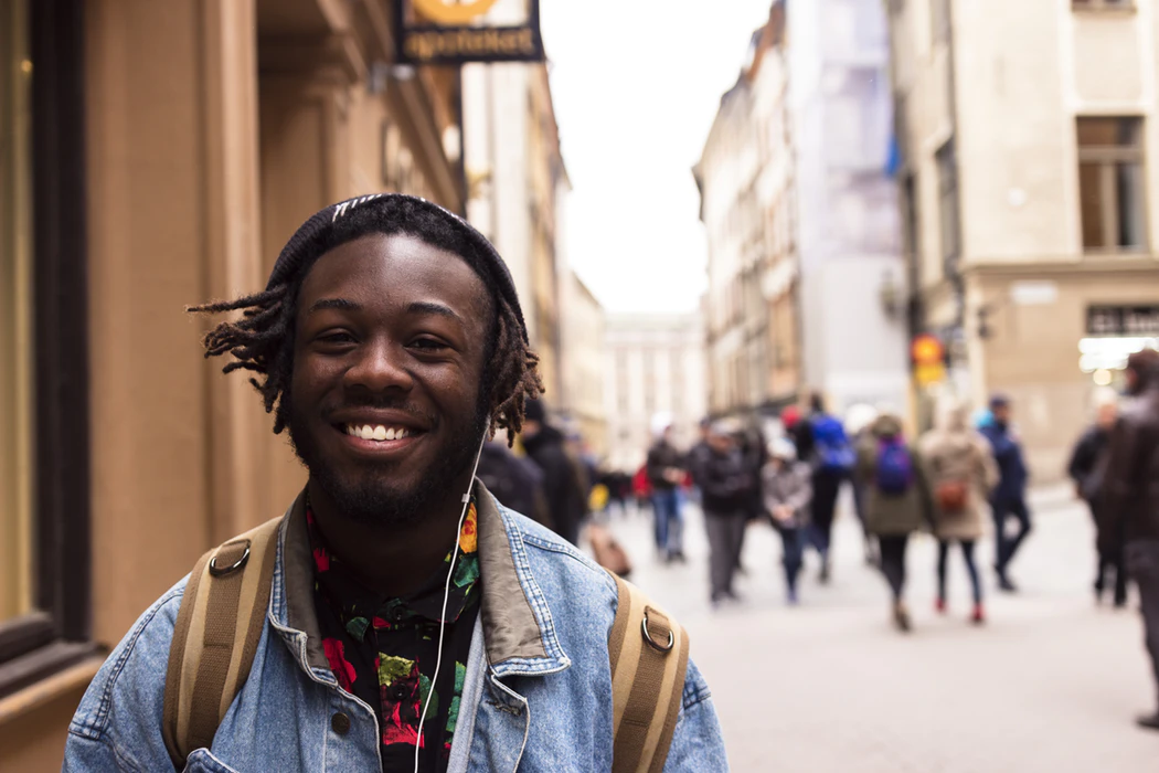 student smiling near building