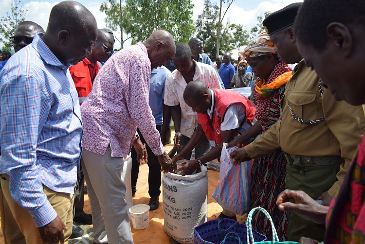 Suba South MP Caroli Omondi and Education CS Ezekiel Machogu distribute relief food to floods affected people at Nyatoto in Suba South on December 11,2023