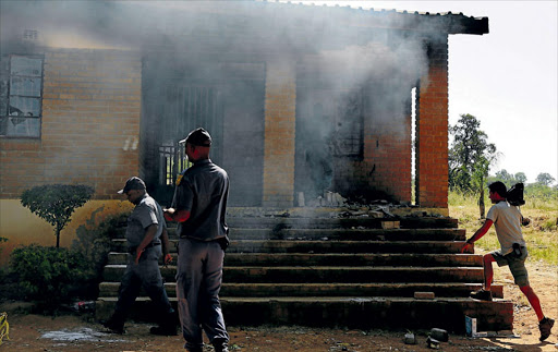 Police conducting a forensic investigation at Maligana Wilson Secondary School which was burnt by protestors in Mashau. Photo: SANDILE NDLOVU