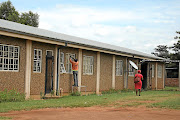 A man replaces the windows at  Mmametlhake Seconday School after Derrick Bopape smashed them with bricks.