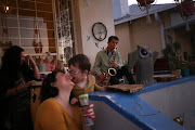 Ben Amato plays the saxophone on his porch while the family entertains the neighbours in Orange Grove during lockdown. From left: Rozanne Myburgh, Amelie Amato, Beth Amato and Gabriel Amato. 