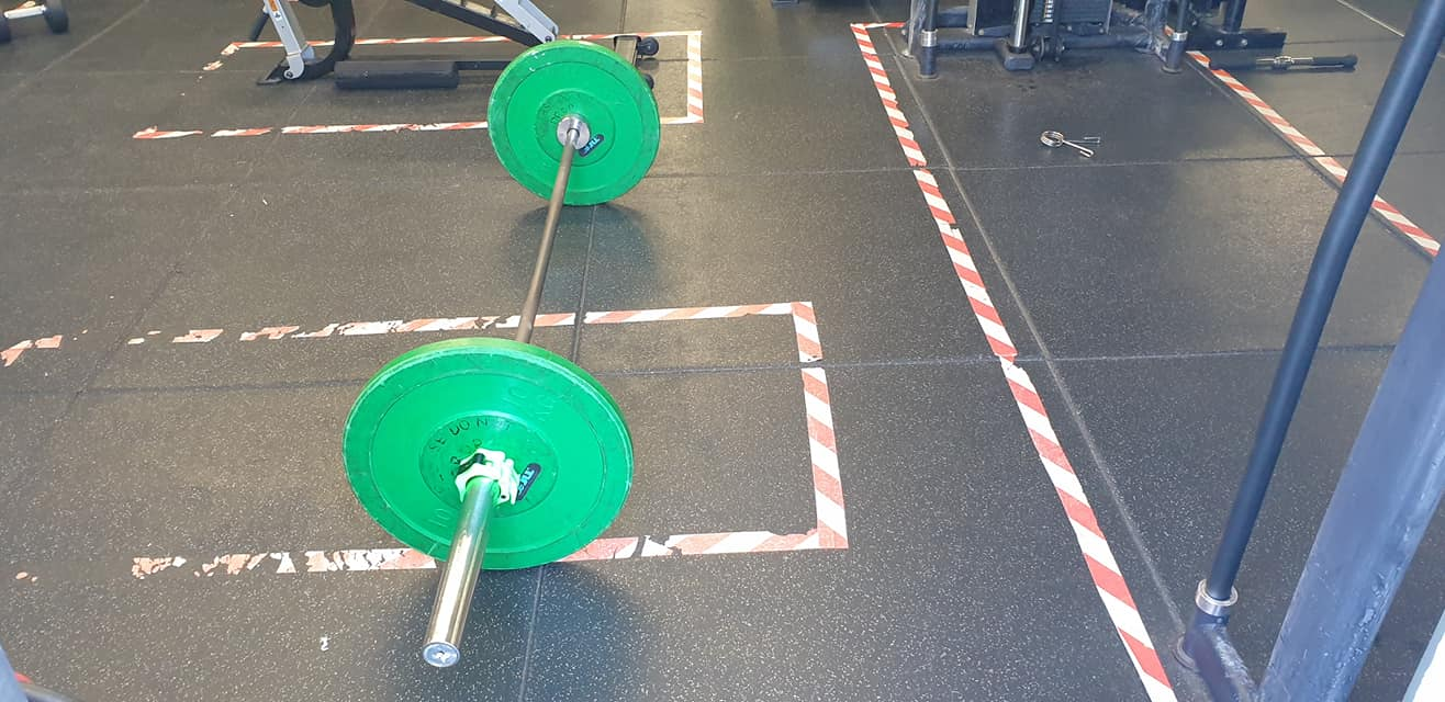 Barbell loaded with weight to prepare for semi sumo deadlift