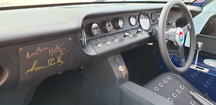 The dashboard of the GT40 on auction is autographed by actors Matt Damon, Christian Bale, movie director James Mangold, and Aaron Shelby.